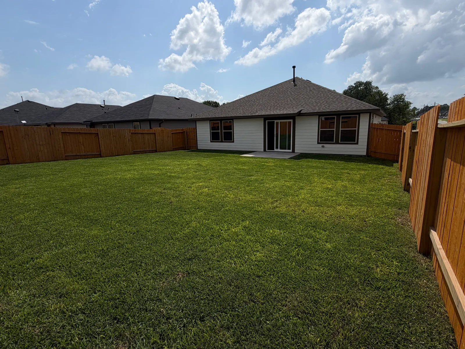 Fenced backyard lawn at 11858 Serena's Song Drive, Willis, TX