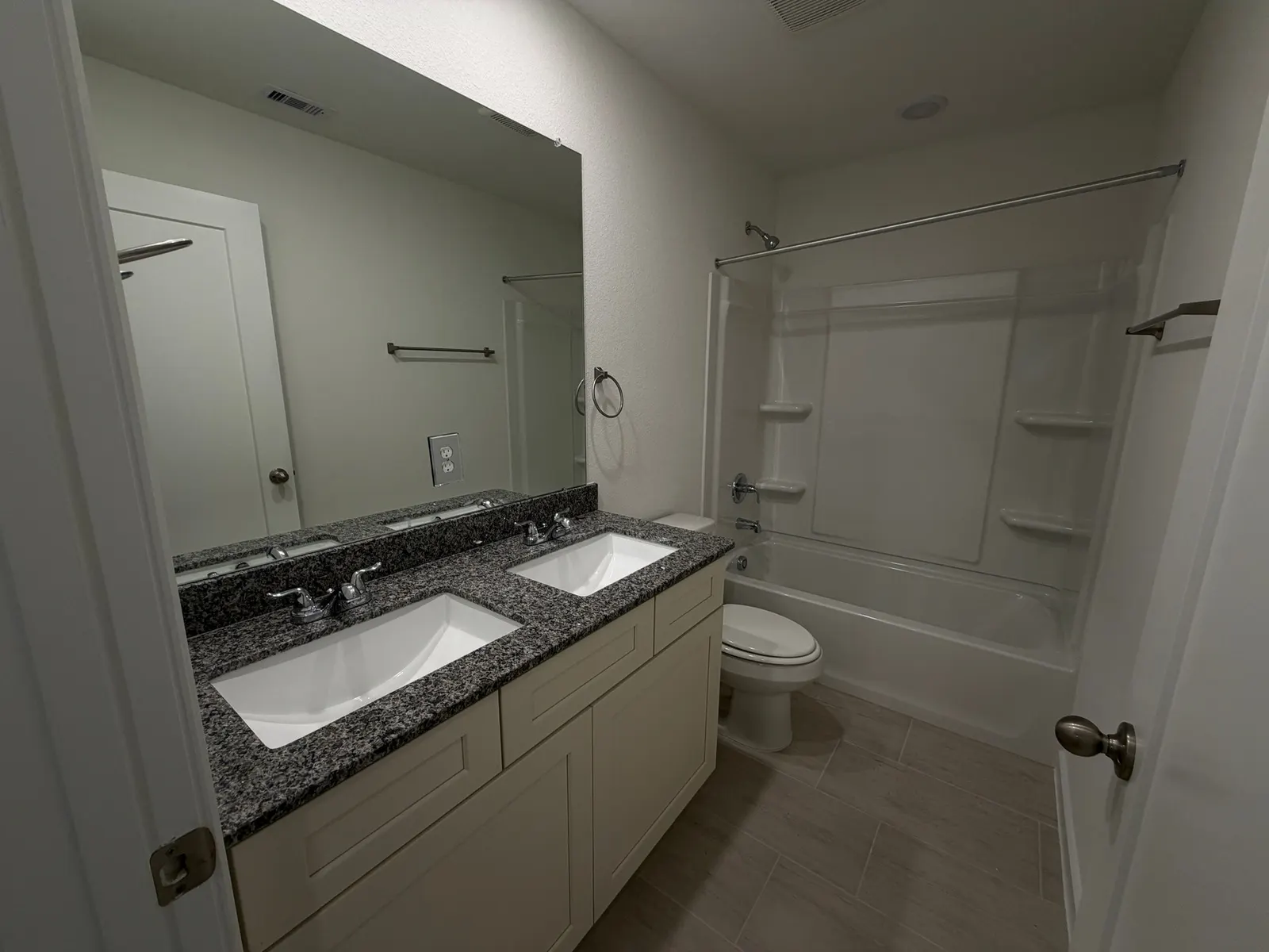 Bathroom with double vanity and tub at 11830 Serena's Song Drive, Willis, TX