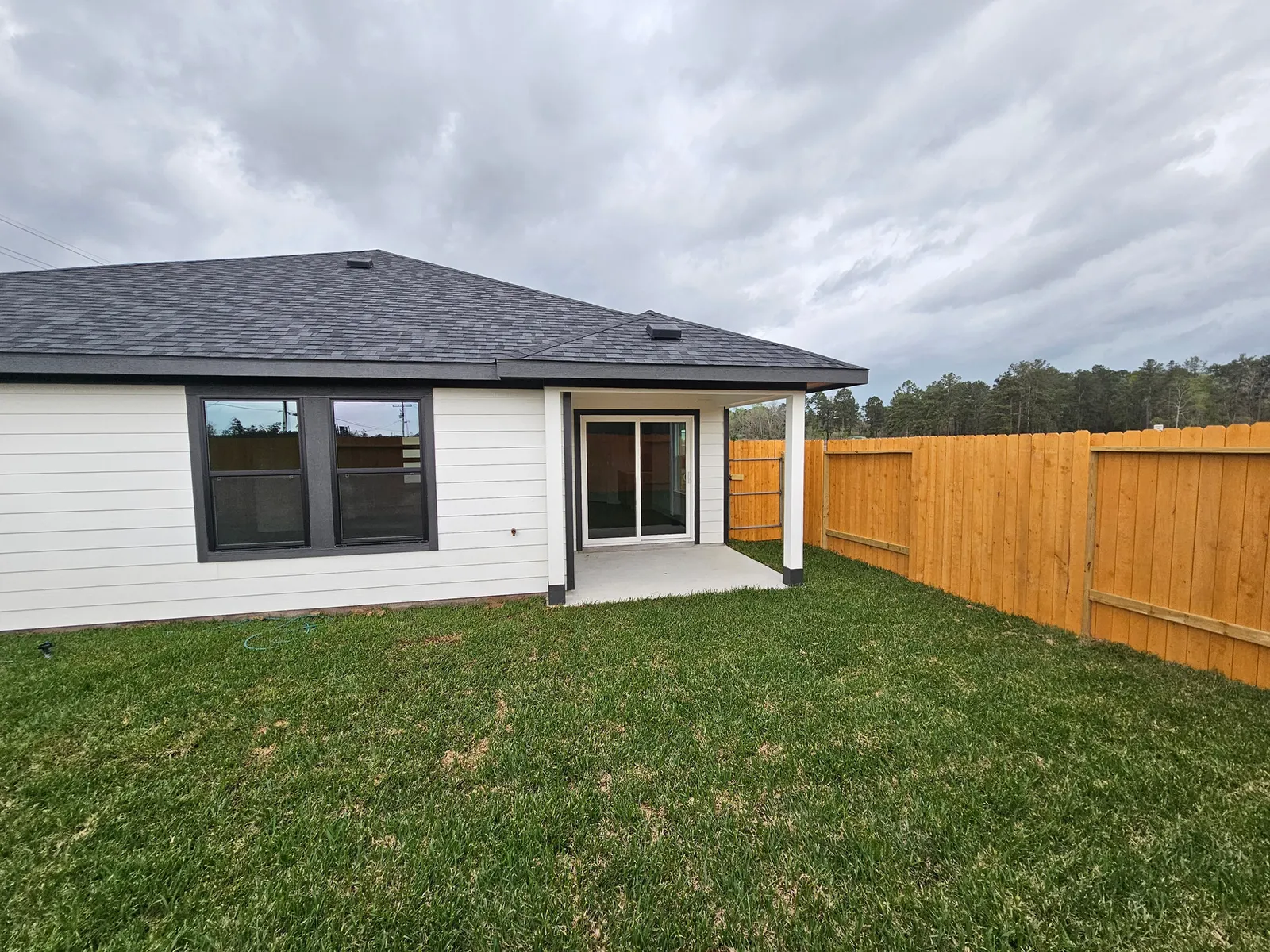Covered patio and fenced backyard at 10727 Crockett Meadows, Conroe, TX