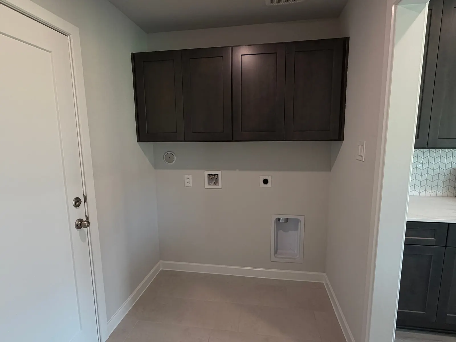Laundry room with cabinets at 11858 Serena's Song Drive, Willis, TX