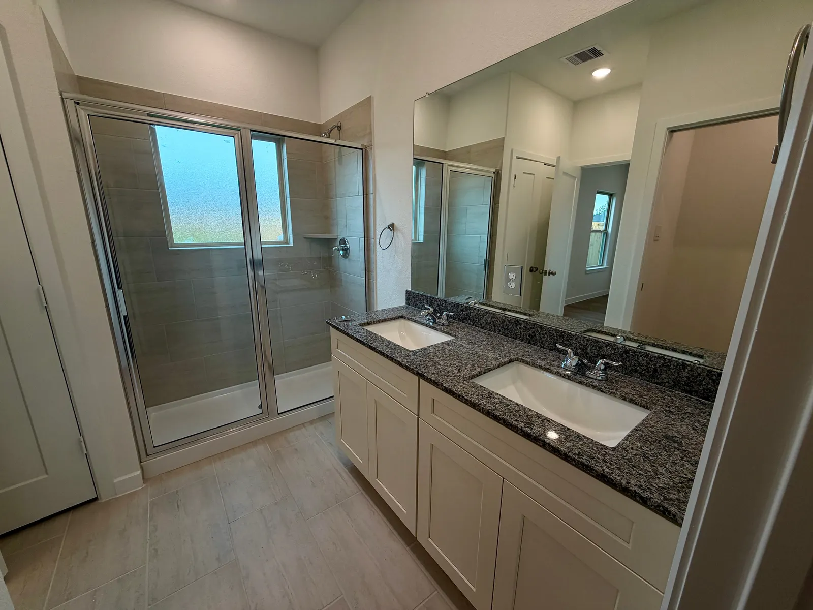 Primary bathroom with vanity and glass shower at 11830 Serena's Song Drive, Willis, TX