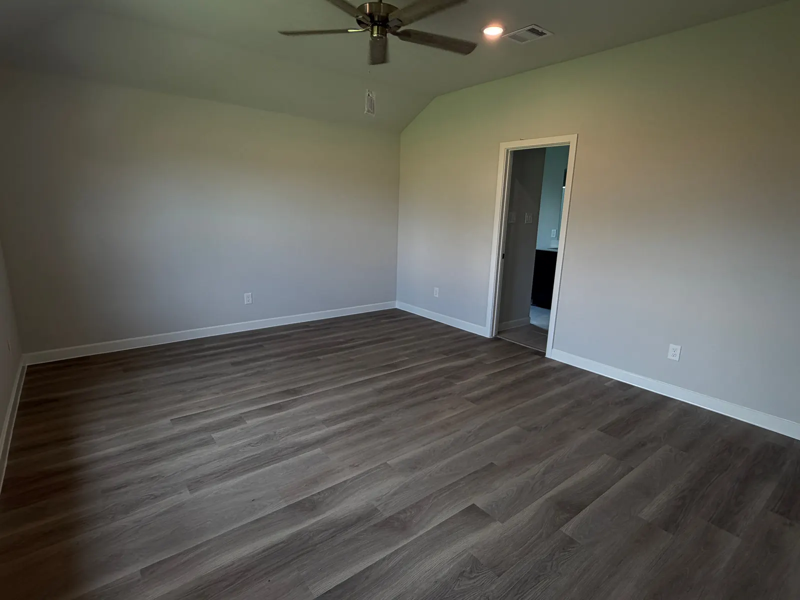 Bedroom with wood look flooring at 11858 Serena's Song Drive, Willis, TX