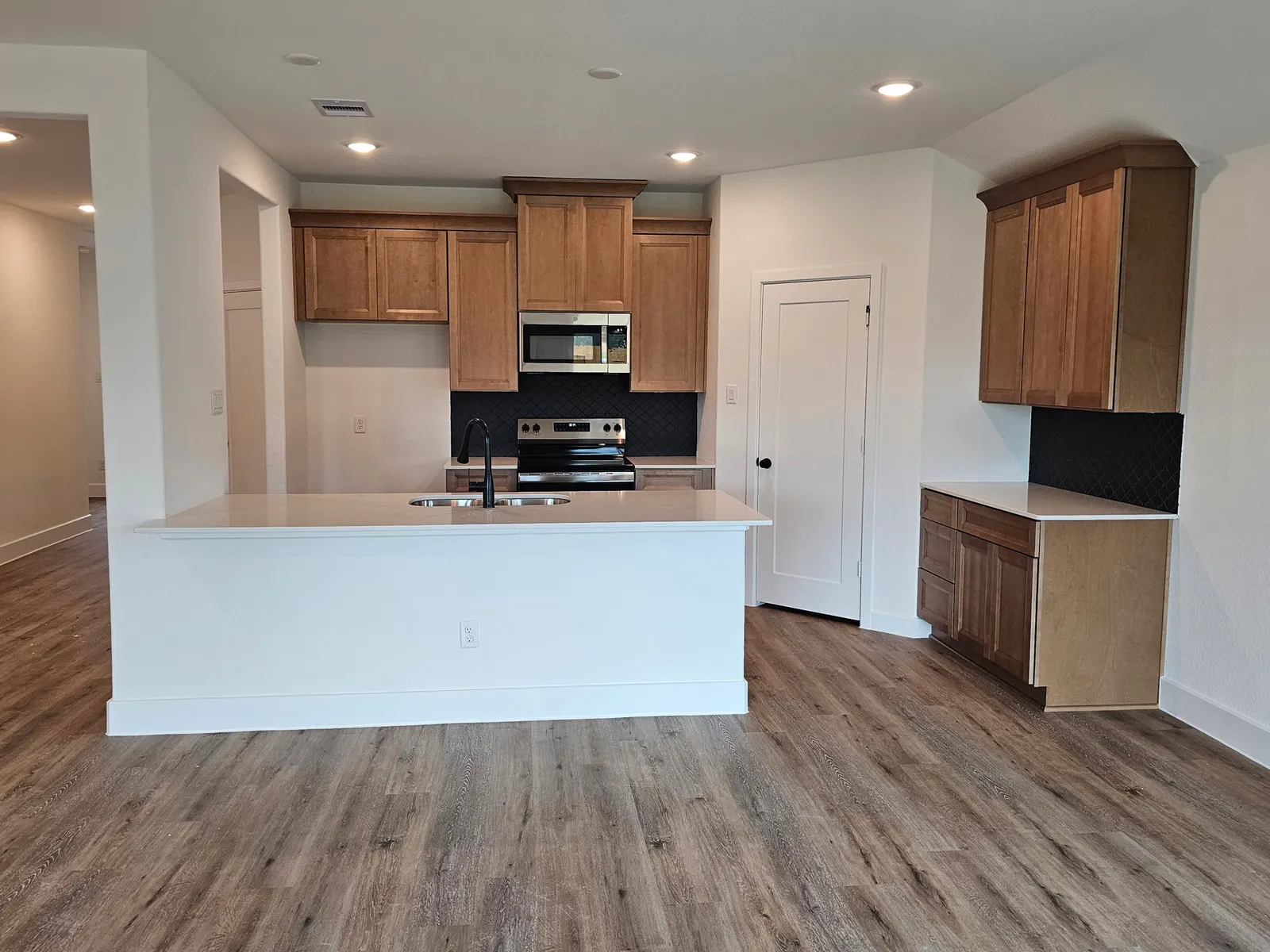 Kitchen with island and stainless appliances at 10727 Crockett Meadows, Conroe, TX