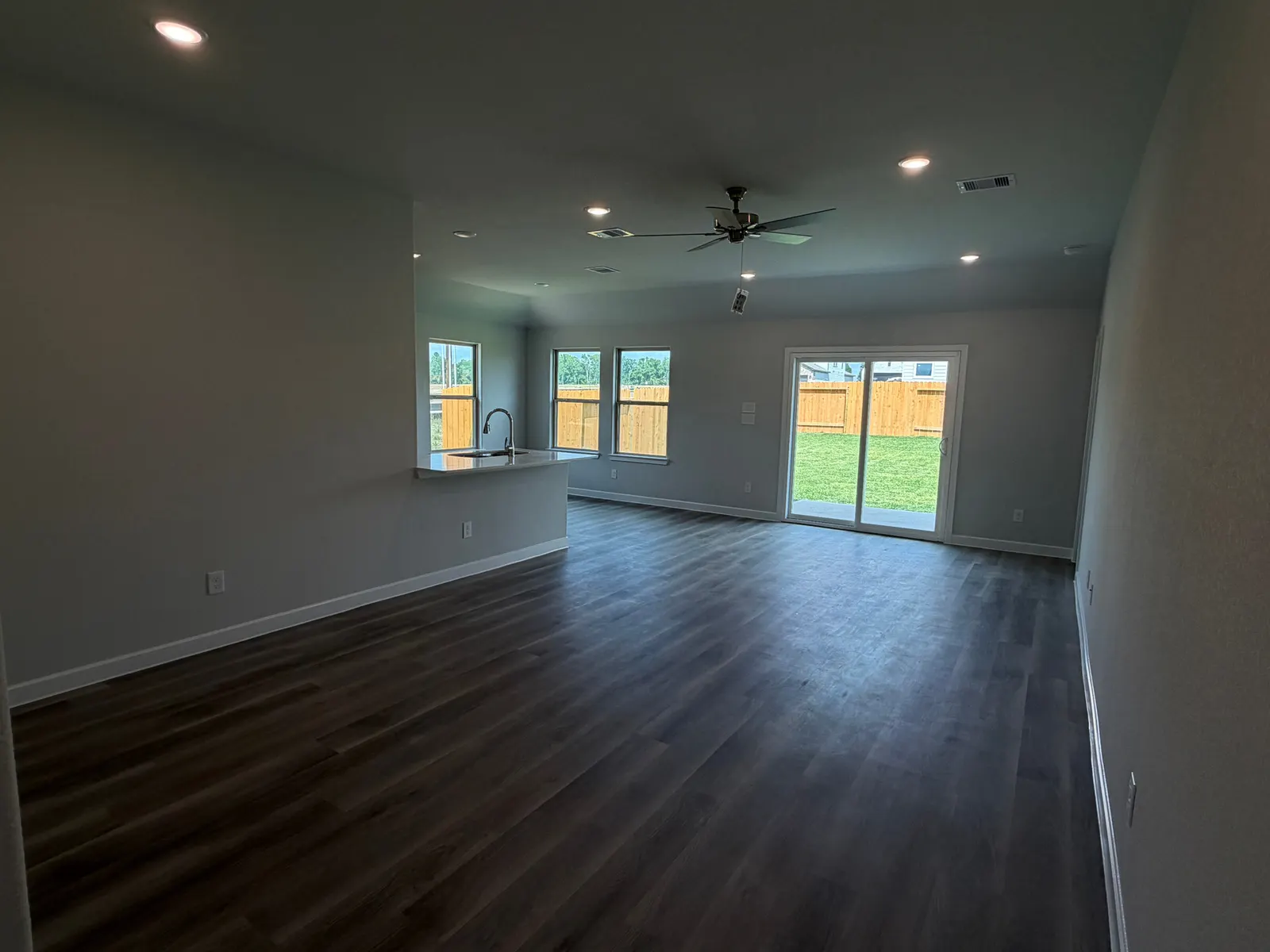 Living and dining area with backyard doors at 11858 Serena's Song Drive, Willis, TX
