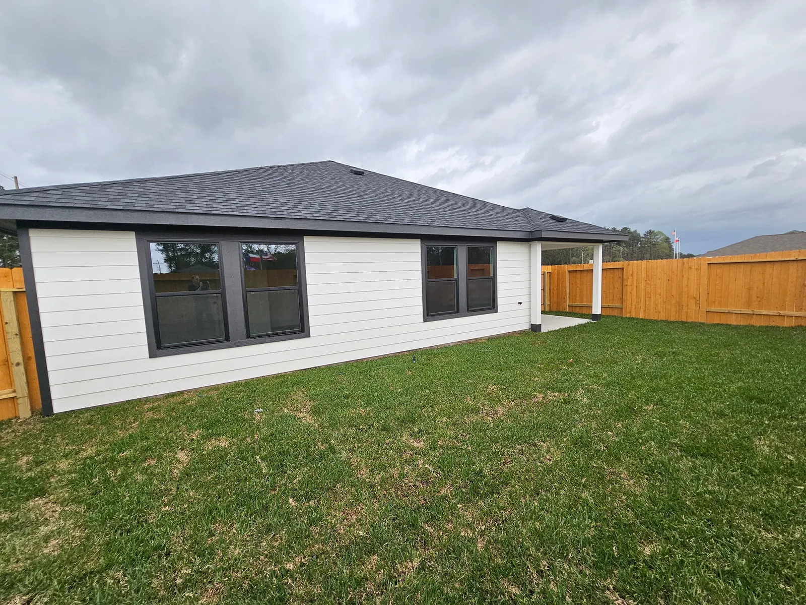 Rear exterior and fenced backyard at 10727 Crockett Meadows, Conroe, TX