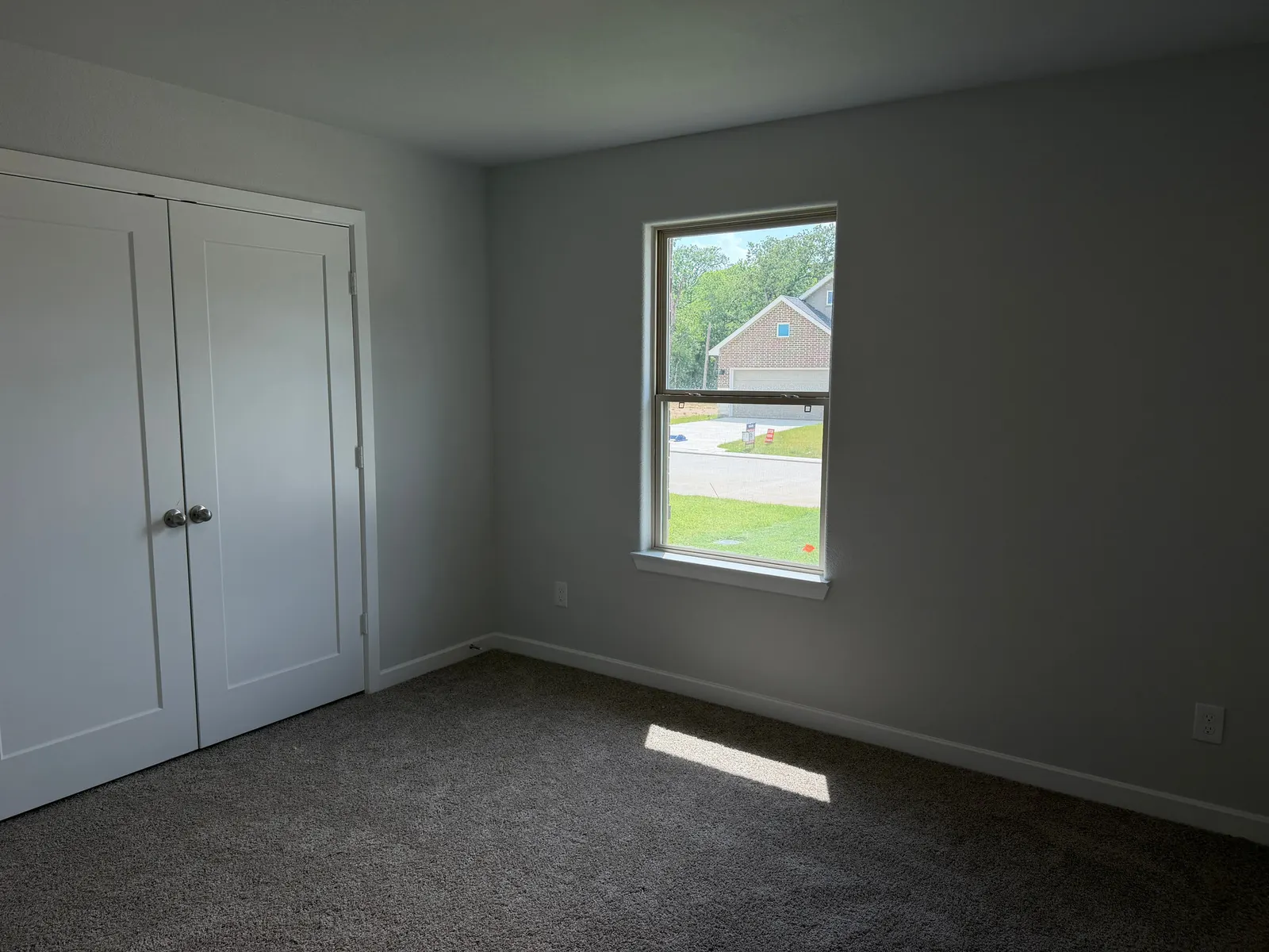 Carpeted bedroom with closet at 11858 Serena's Song Drive, Willis, TX