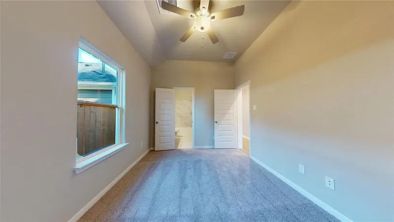Bedroom with ceiling fan and window at 16701 Eastchase Street, Montgomery, TX