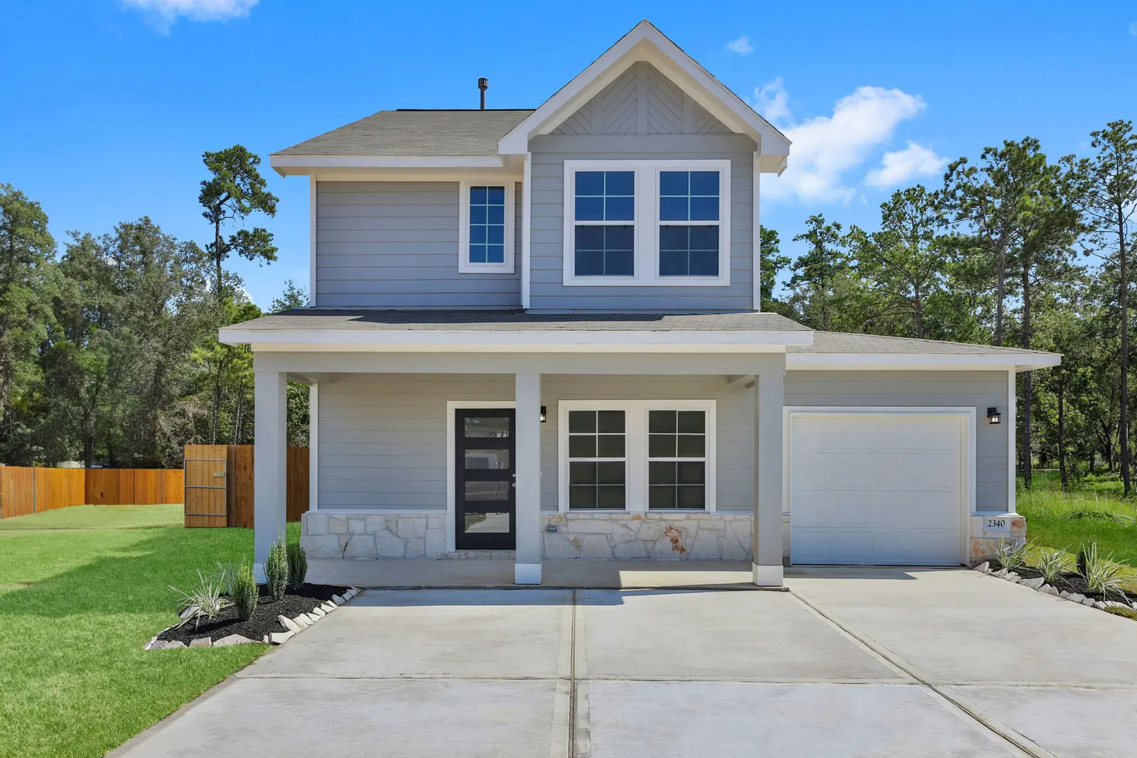 Two story front exterior with garage at Lake Conroe Village, Montgomery, TX