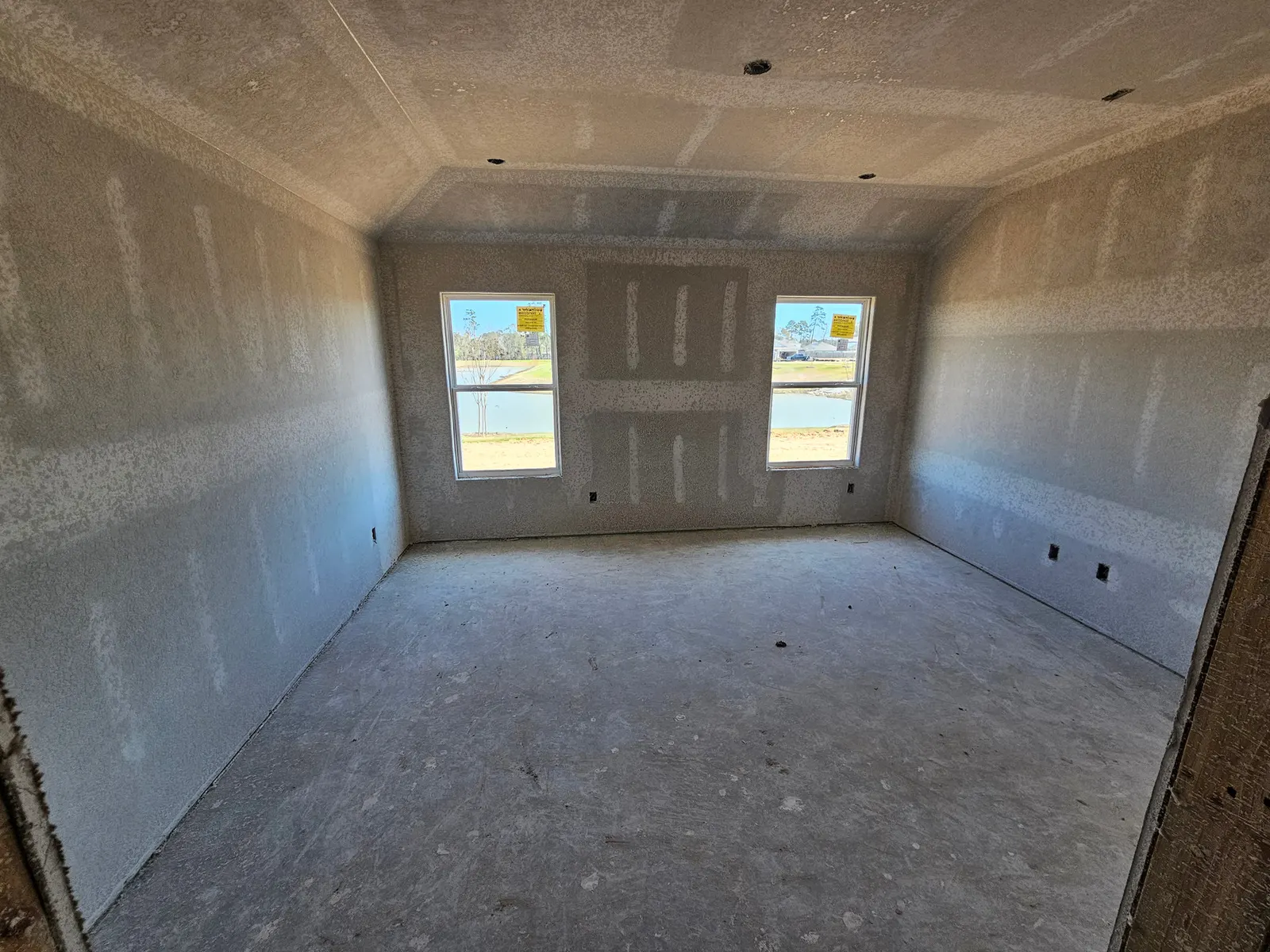 Room with two windows at drywall stage at 10715 Crockett Meadows, Conroe, TX