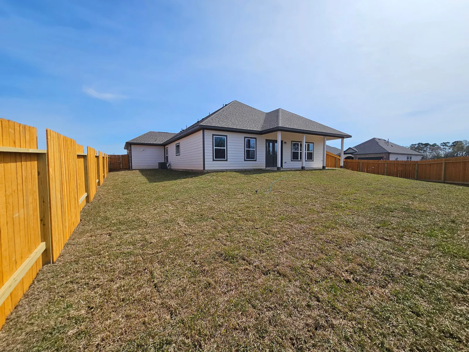 Rear elevation and fenced backyard at 11803 Serena's Song Drive, Willis, TX