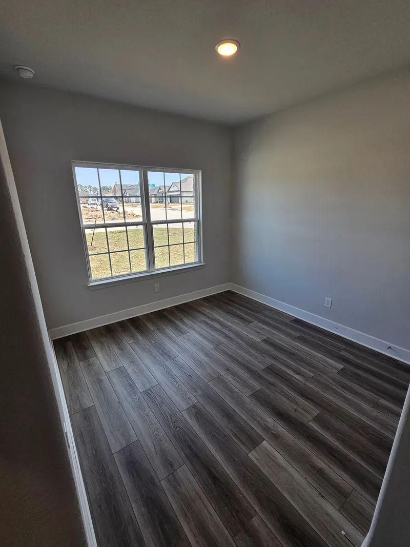 Bedroom with large window at 11803 Serena's Song Drive, Willis, TX