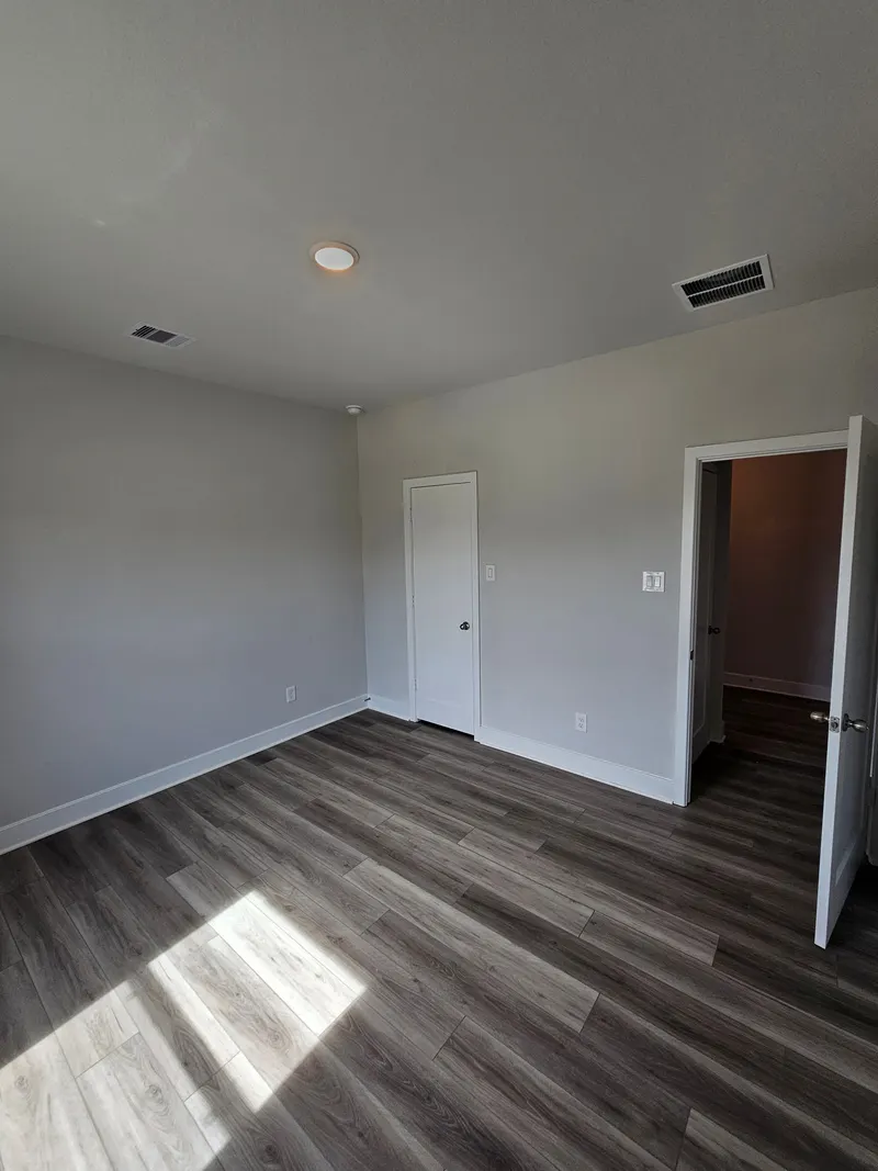 Bedroom with hallway door at 11803 Serena's Song Drive, Willis, TX