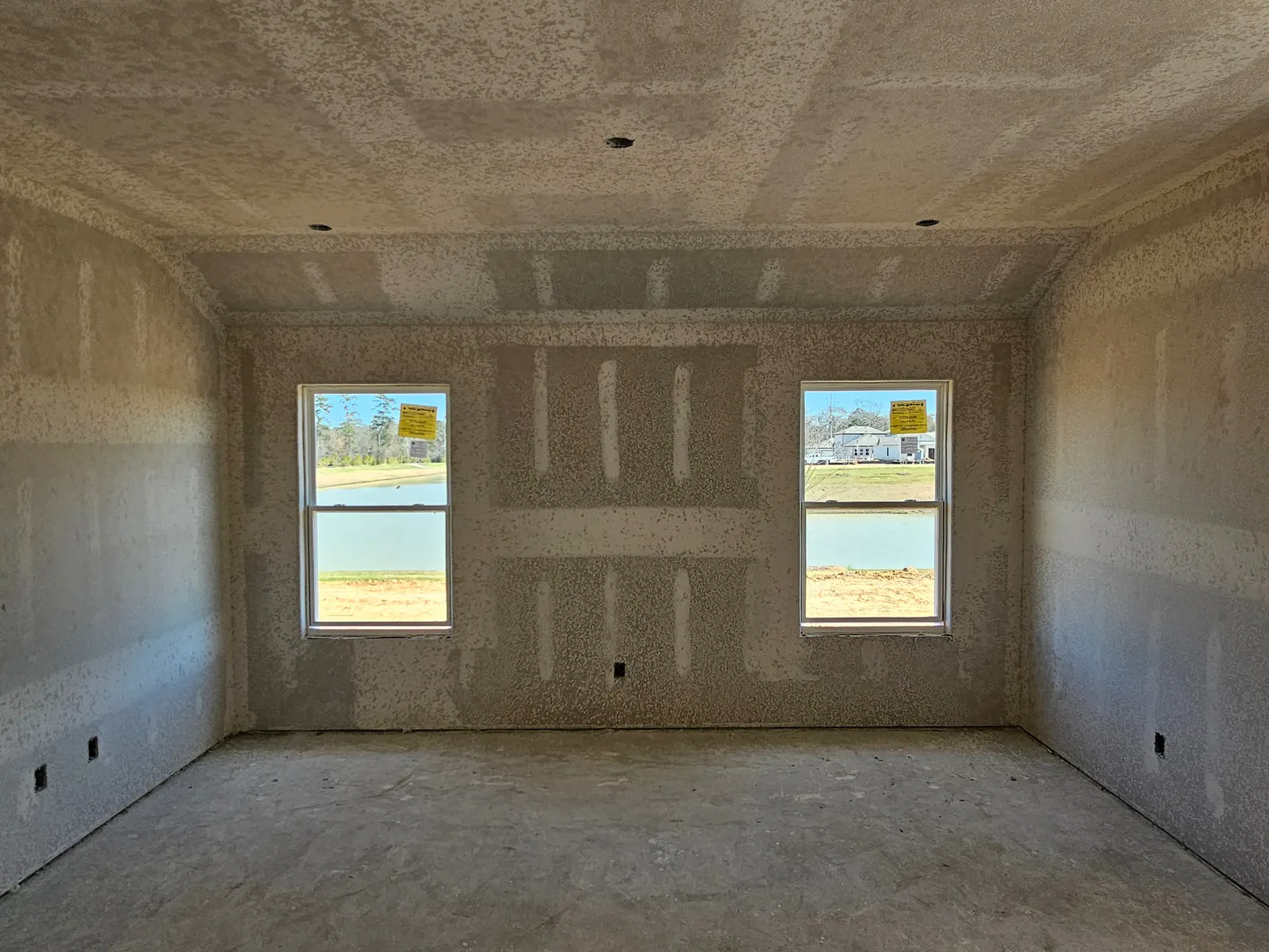 Bedroom with two windows at drywall stage at 10715 Crockett Meadows, Conroe, TX