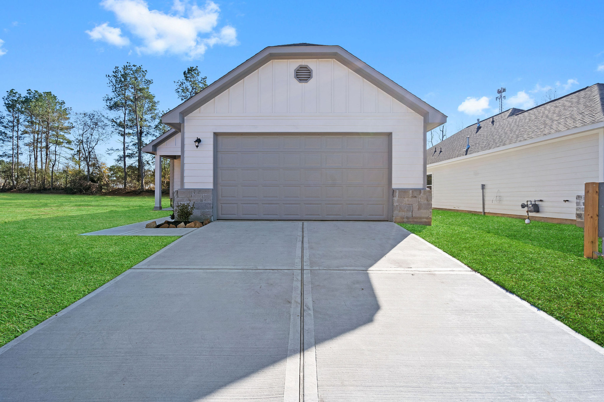 Front exterior with driveway and two car garage at Cedar Crossing by Alta Homes
