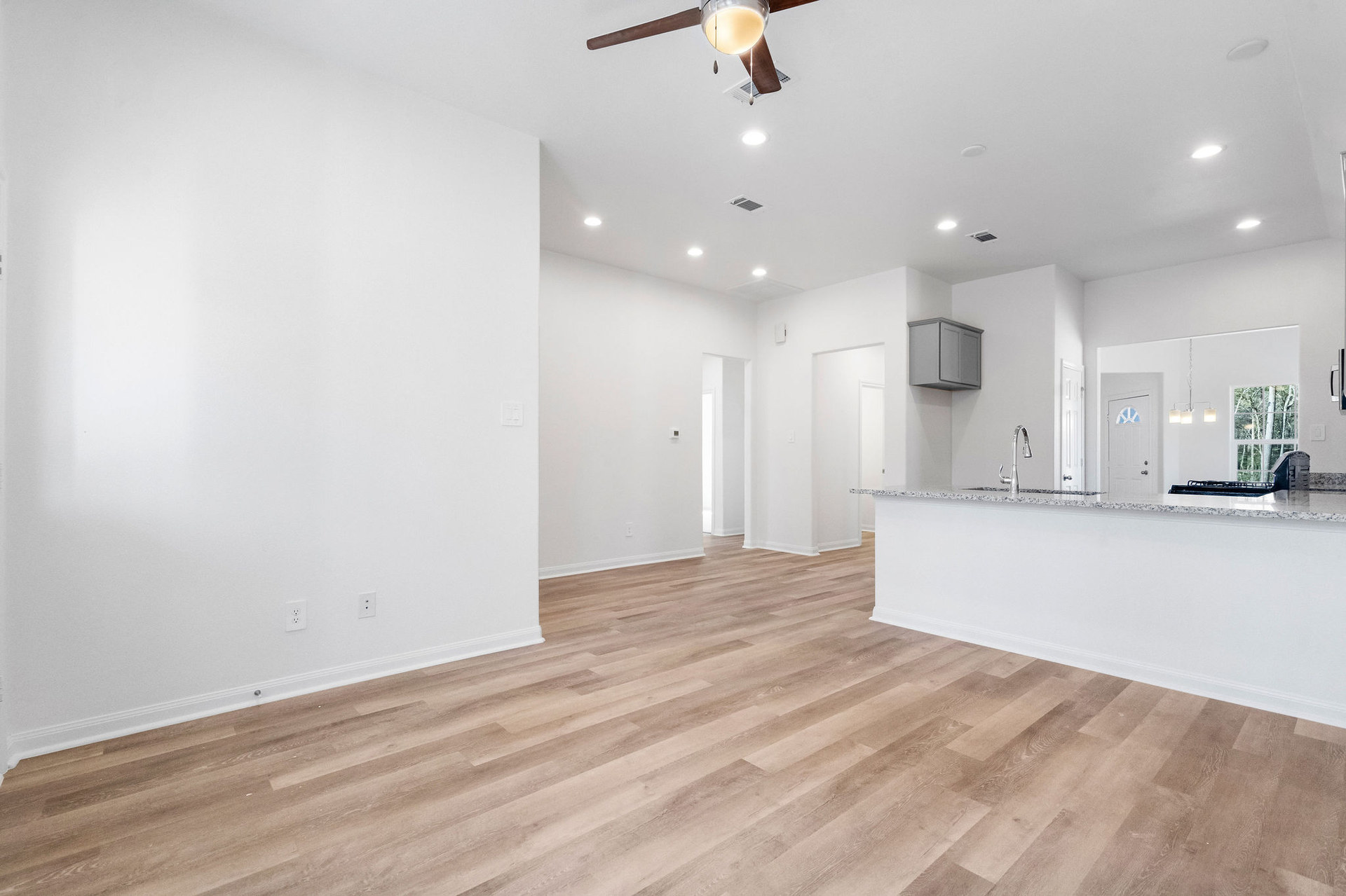 Open living area looking toward the kitchen at Cedar Crossing by Alta Homes