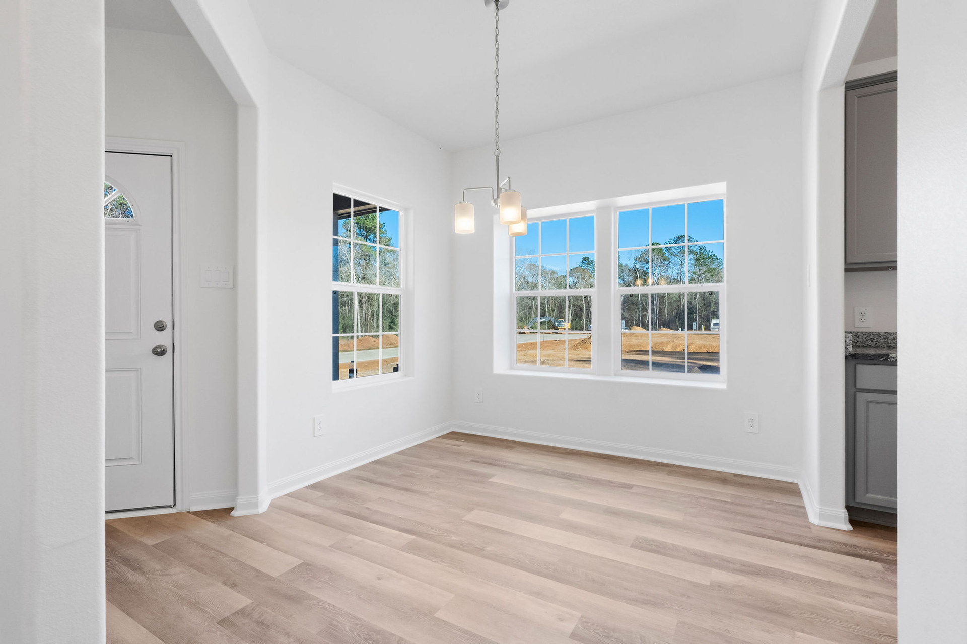Dining area with windows near the front door at Cedar Crossing by Alta Homes