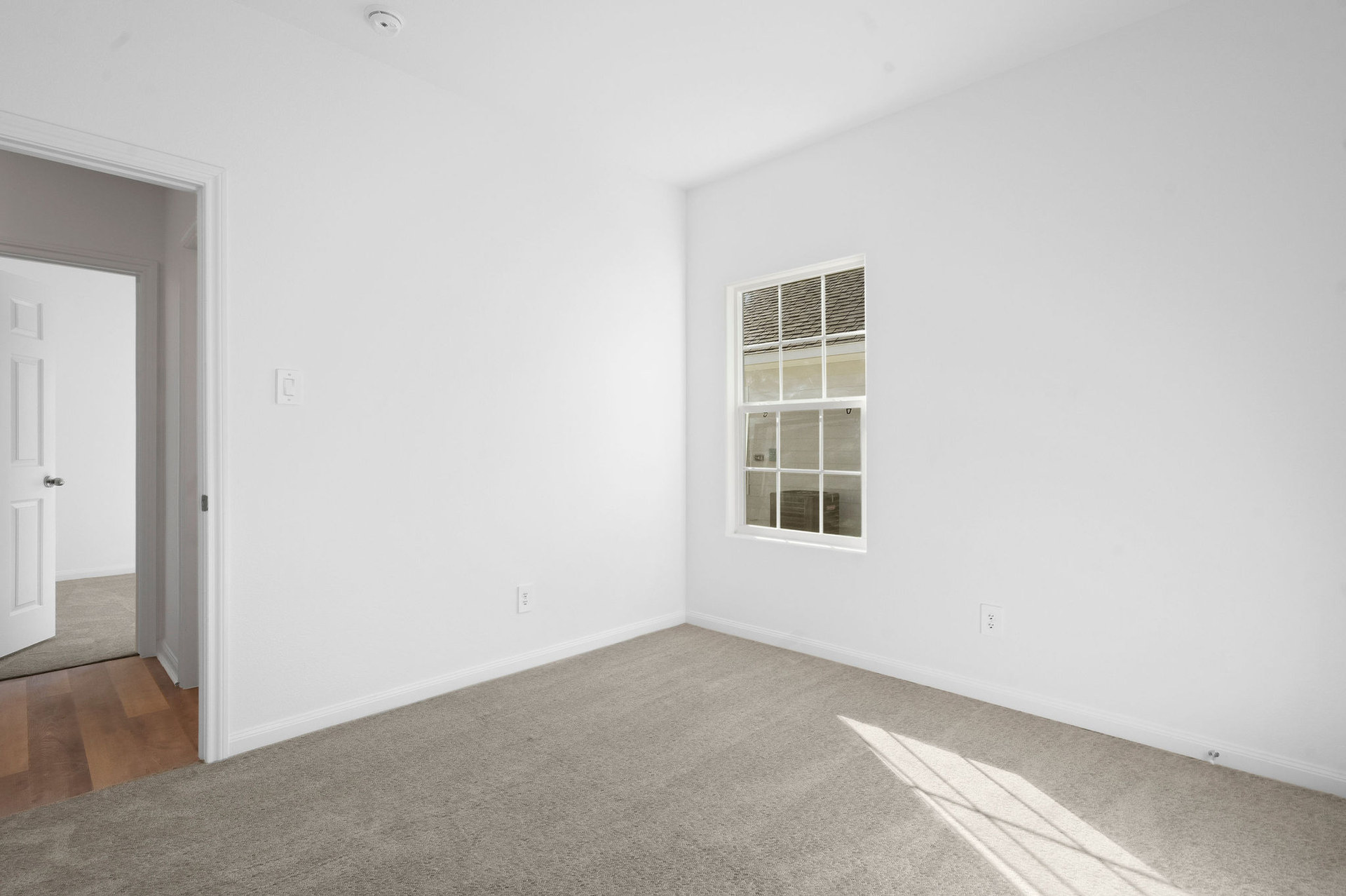 Carpeted bedroom at Cedar Crossing by Alta Homes