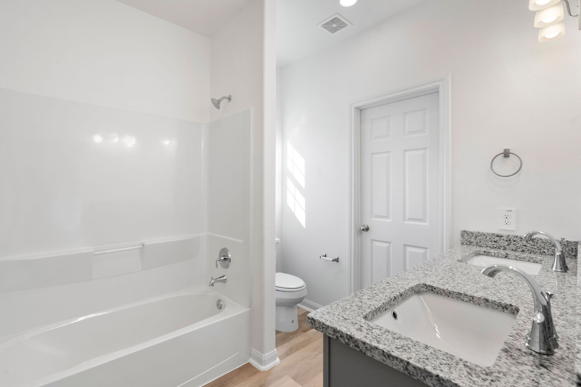Bathroom with tub, toilet and vanity at Cedar Crossing by Alta Homes